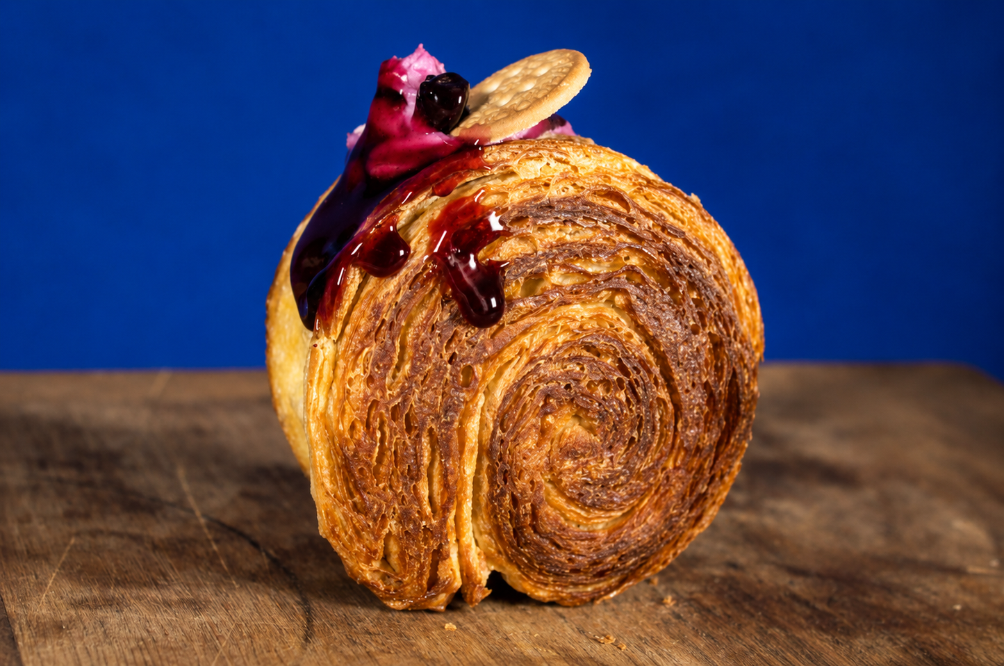Blueberry Cheesecake filled circular croissant with berry topping close-up | Dough Couture