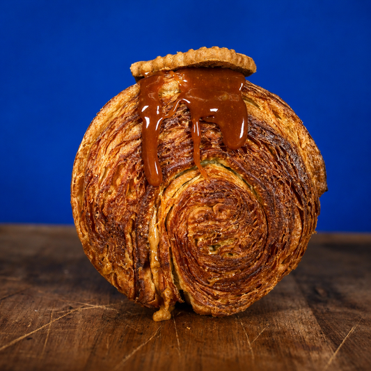 Biscoff filled circular croissant standing upright showing golden flaky swirl pattern | Dough Couture