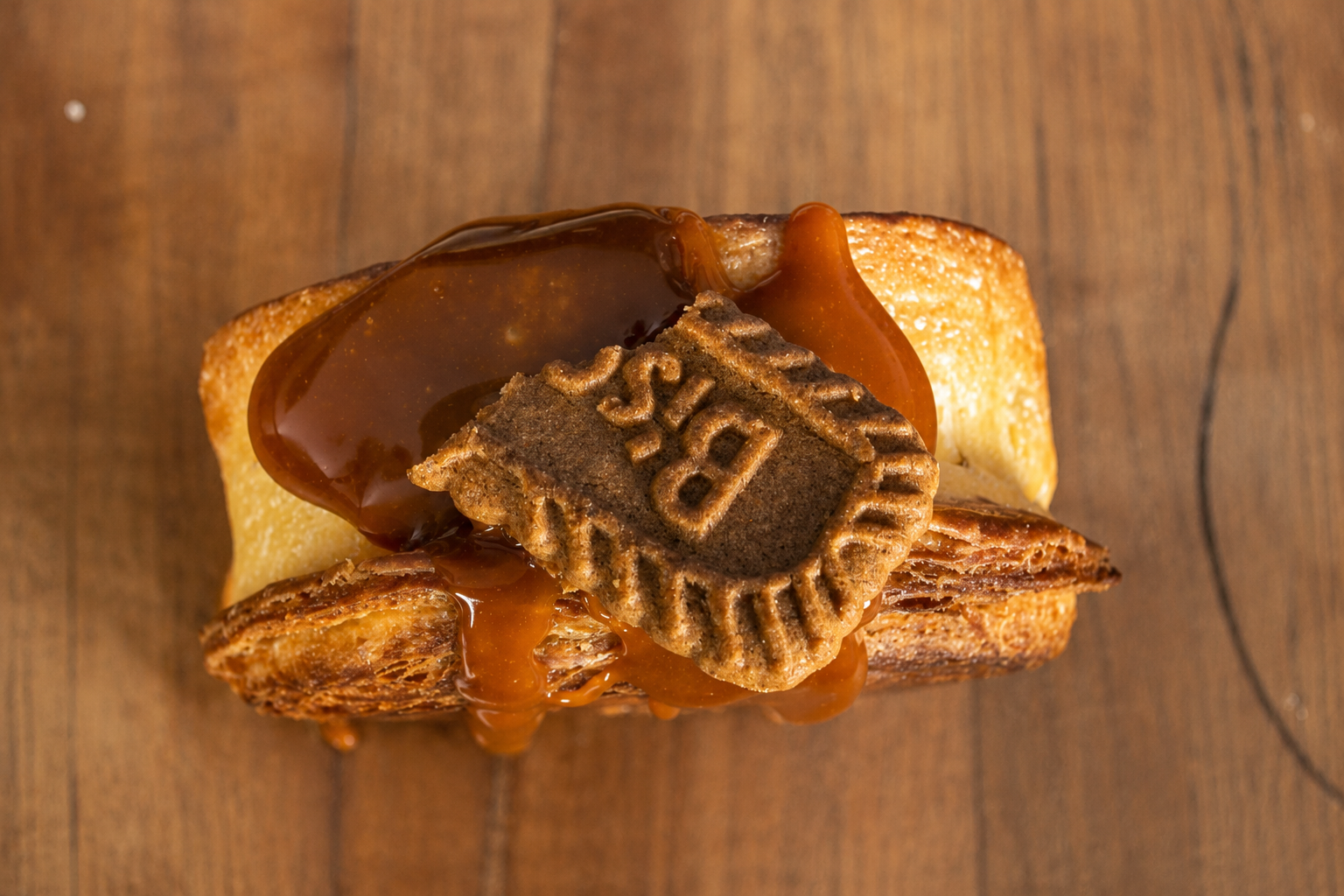 Biscoff filled circular croissant with caramelised cookie butter topping close-up | Dough Couture